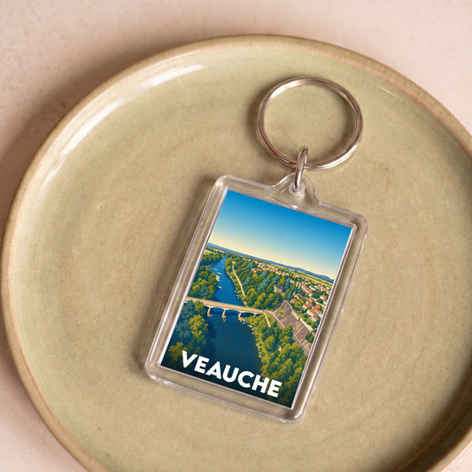 Porte-clés souvenir de la ville de Veauche avec une illustration stylisée.