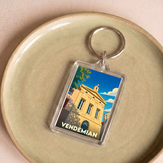 Porte-clés souvenir de la ville de Vendémian avec une illustration stylisée de sa mairie.