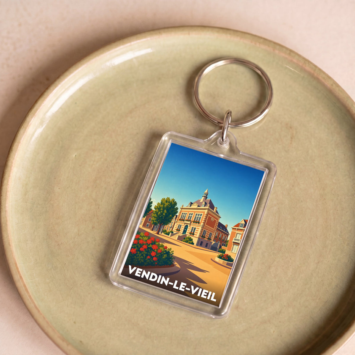 Porte-clés souvenir de la ville de Vendin-le-Vieil avec une illustration stylisée.