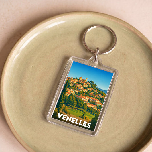 Porte-clés souvenir de la ville de Venelles avec une illustration stylisée.