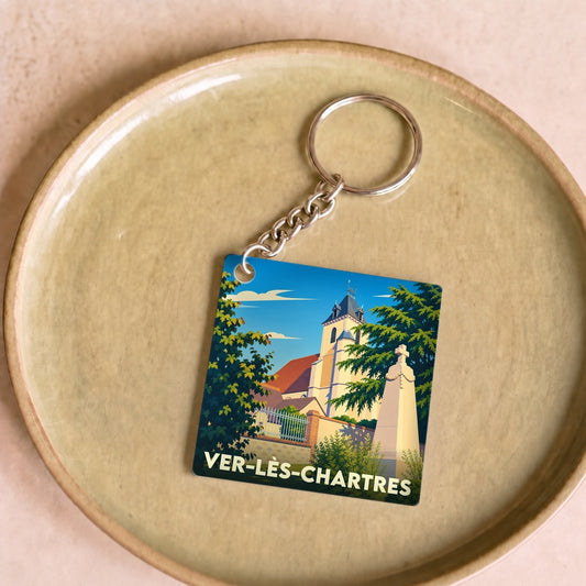 Porte-clés souvenir de la ville de Ver-lès-Chartres avec une illustration stylisée de son église.