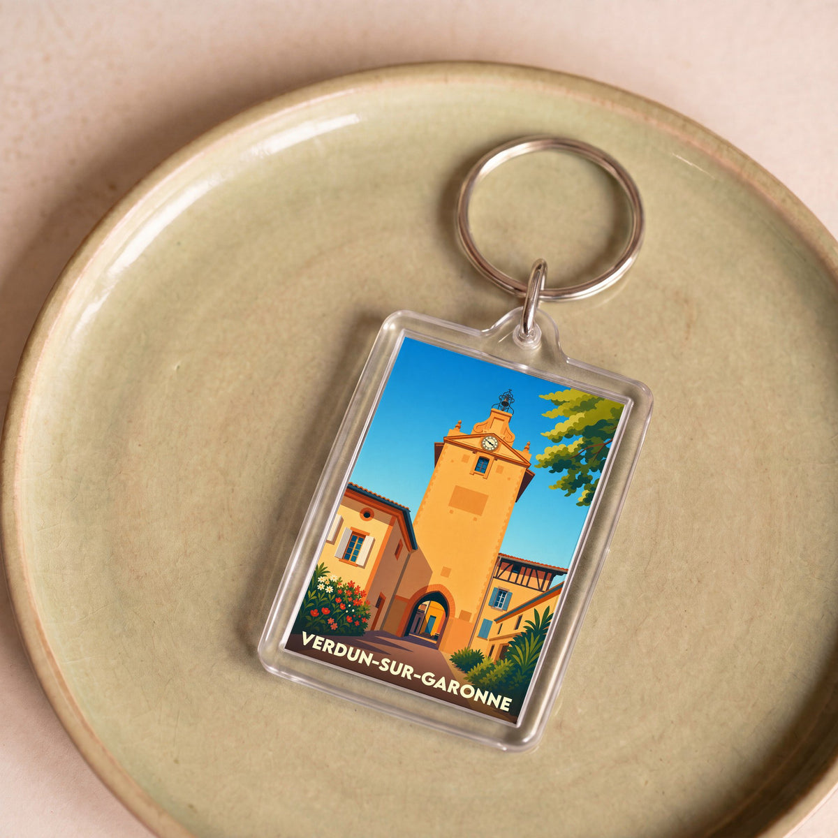 Porte-clés souvenir de la ville de Verdun-sur-Garonne avec une illustration stylisée de sa tour de l'horloge.