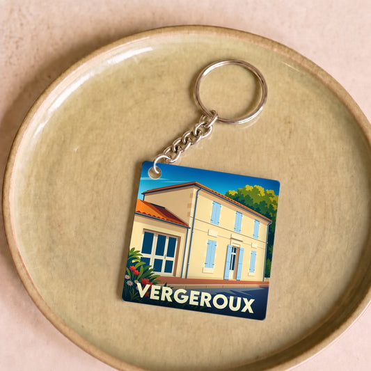 Porte-clés souvenir de la ville de Vergeroux avec une illustration stylisée d'une maison charentaise.