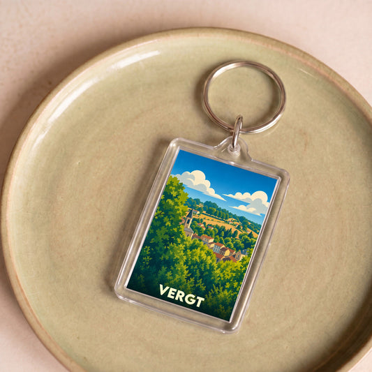 Porte-clés souvenir de la ville de Vergt avec une illustration stylisée d'un paysage vallonné.