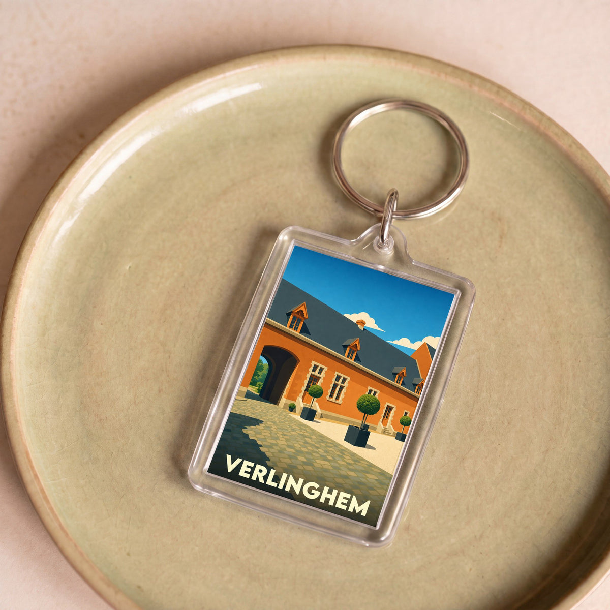 Porte-clés souvenir de la ville de Verlinghem avec une illustration stylisée.