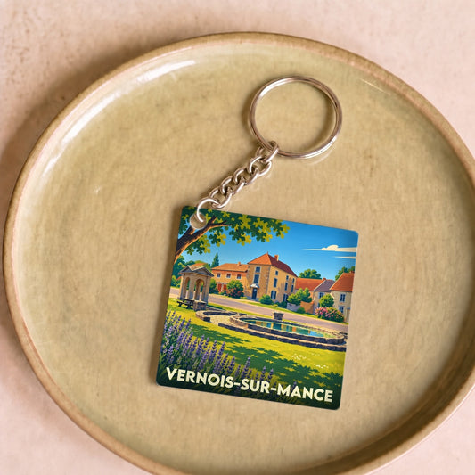 Porte-clés souvenir de la ville de Vernois-sur-Mance avec une illustration colorée et stylisée.