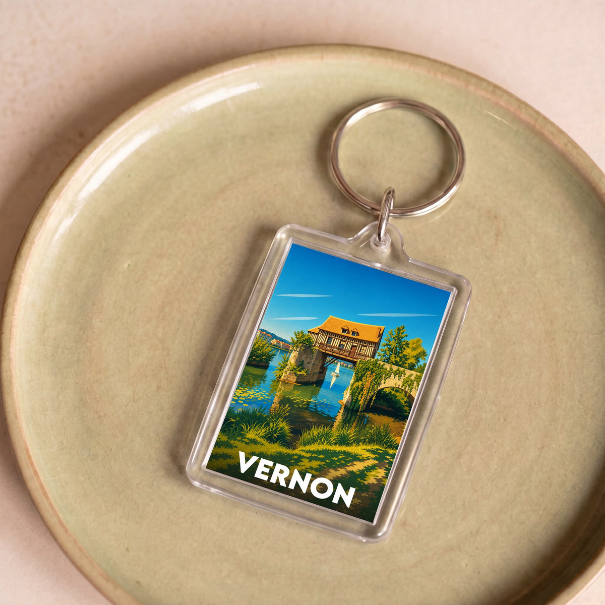 Porte-clés souvenir de la ville de Vernon avec une illustration stylisée.