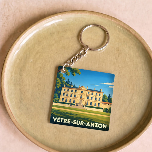 Porte-clés souvenir de la ville de Vêtre-sur-Anzon avec une illustration stylisée d'un château.