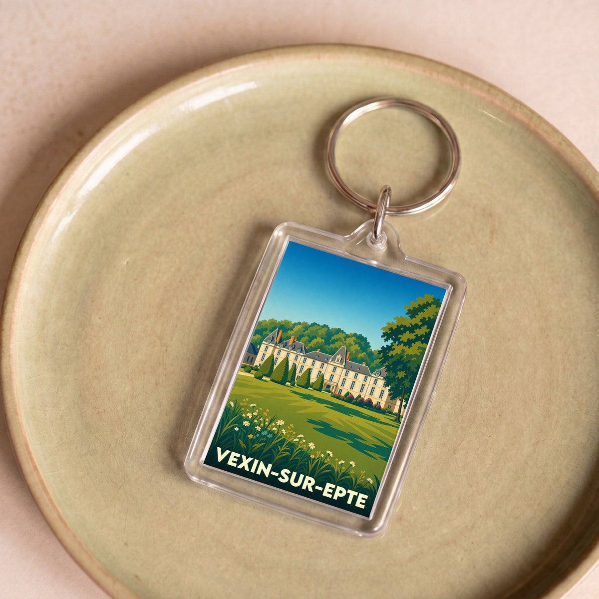 Porte-clés souvenir de la ville de Vexin-sur-Epte avec une illustration stylisée d'un château.