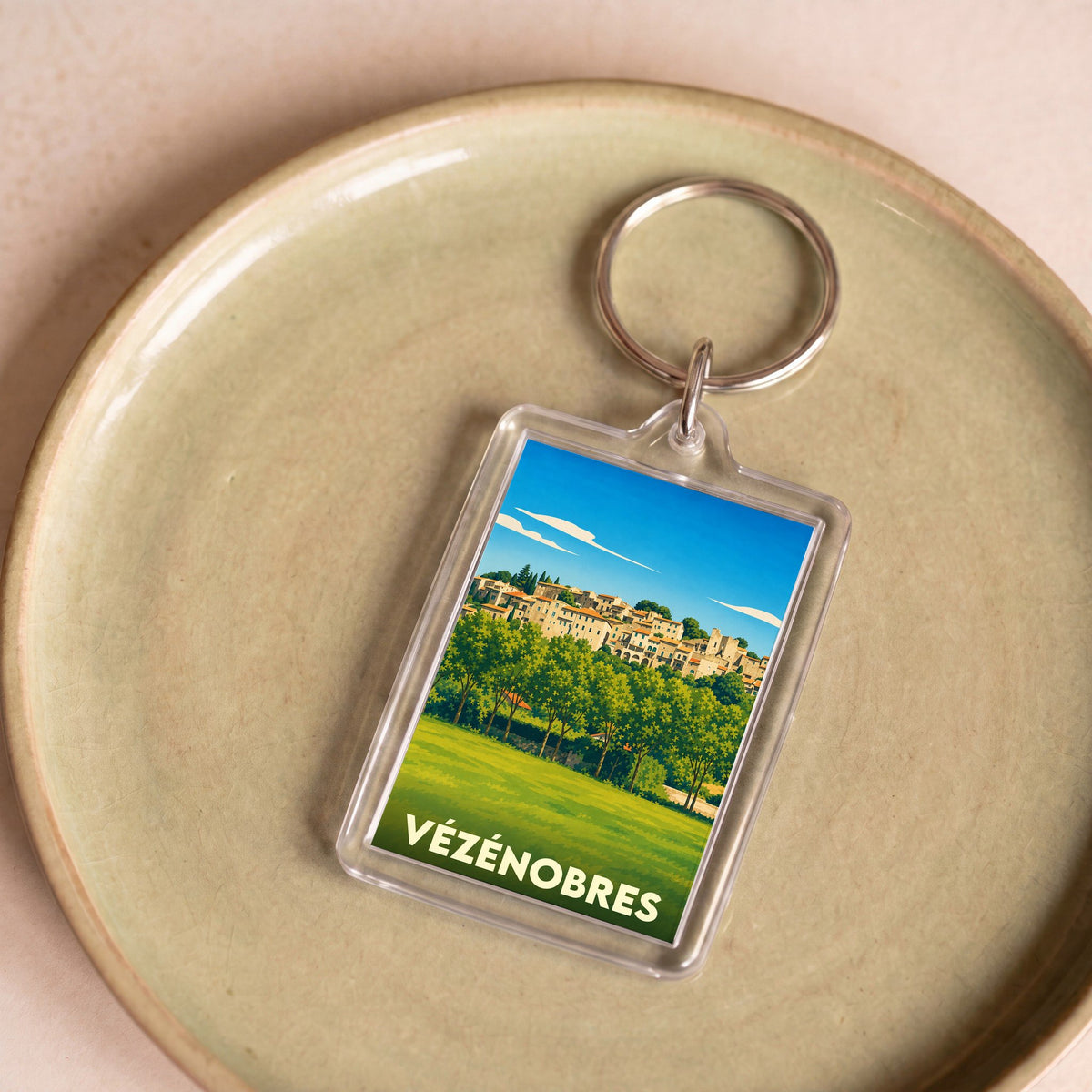 Porte-clés souvenir de la ville de Vézénobres avec une illustration stylisée.