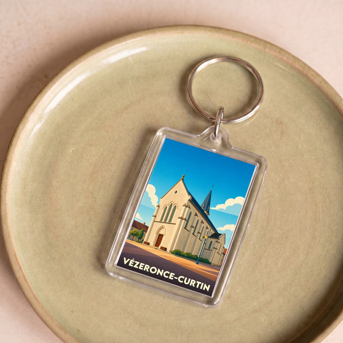 Porte-clés souvenir de la commune de Vézeronce-Curtin avec une illustration stylisée de son église.