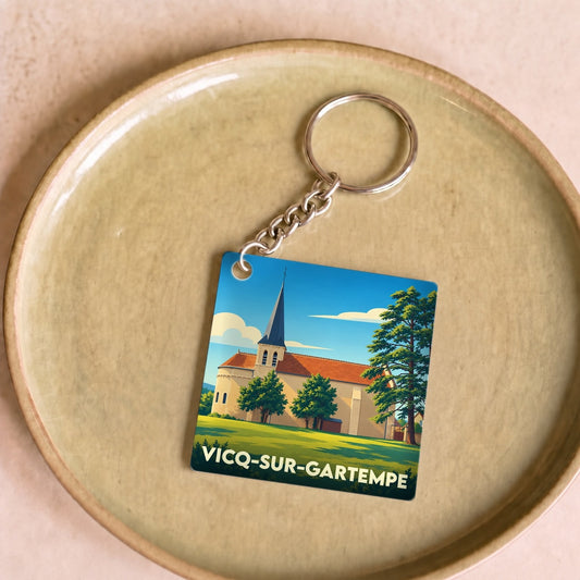Porte-clés souvenir de la ville de Vicq-sur-Gartempe avec une illustration stylisée de son église.