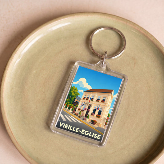 Porte-clés souvenir de la ville de Vieille-Église avec une illustration stylisée.