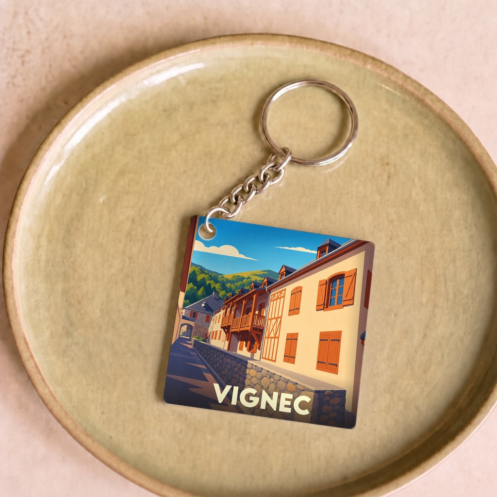 Porte-clés souvenir de la ville de Vignec avec une illustration stylisée de ses façades traditionnelles.
