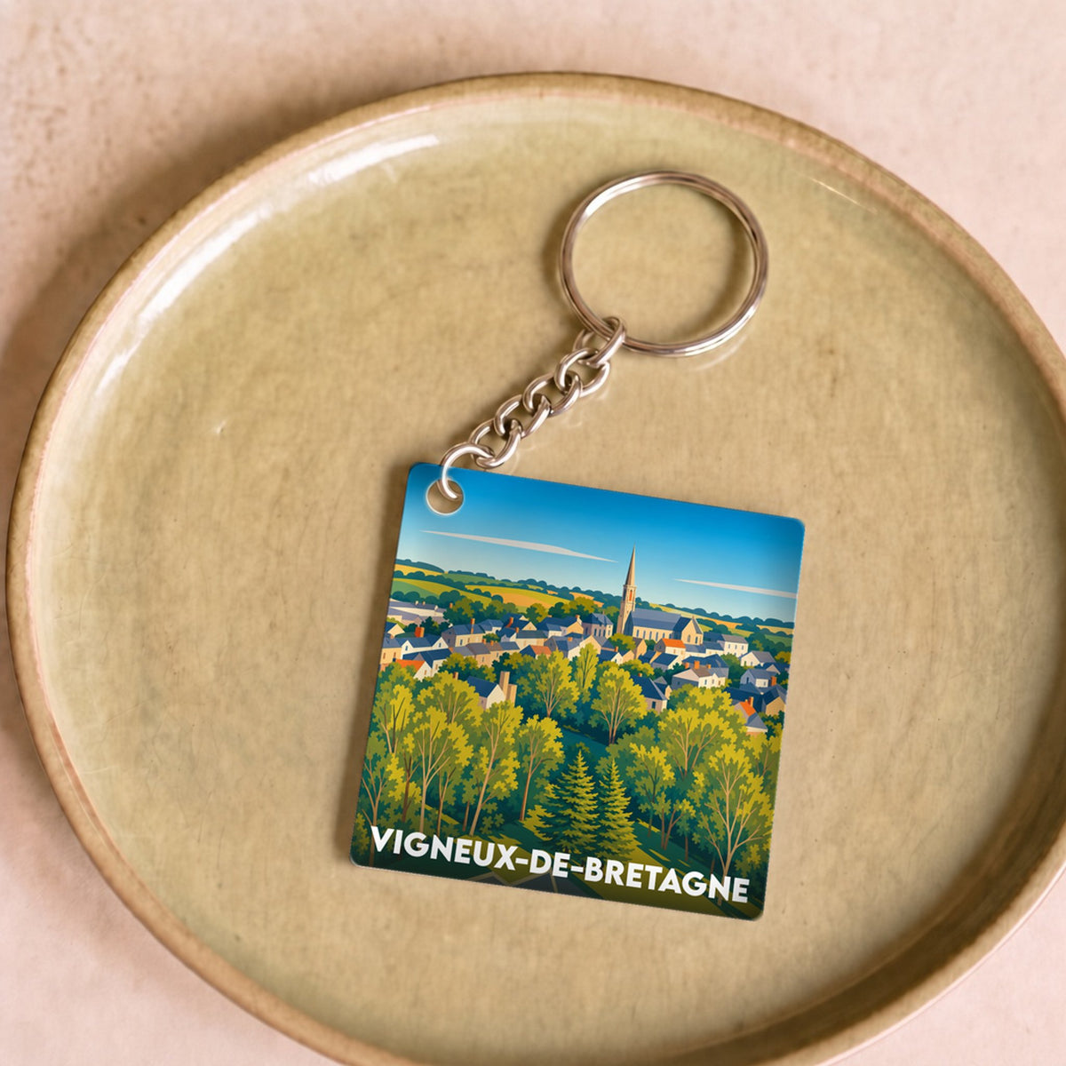 Porte-clés souvenir de la ville de Vigneux-de-Bretagne avec une illustration stylisée.