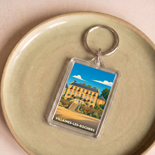 Porte-clés souvenir de la ville de Villaines-les-Rochers avec une illustration colorée et stylisée.