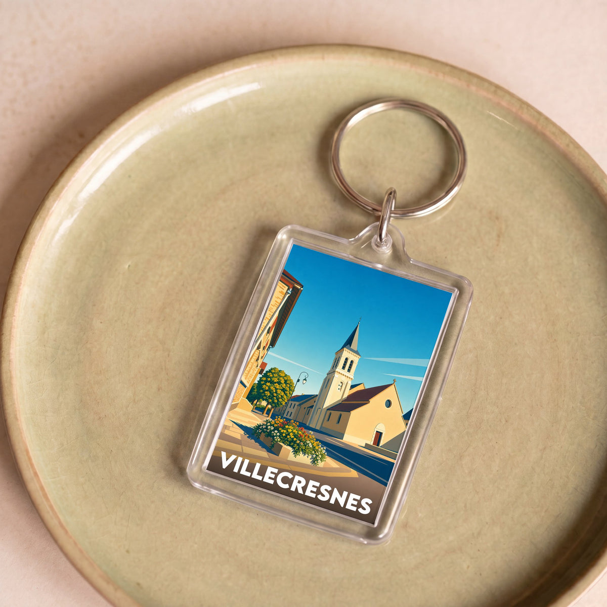 Porte-clés souvenir de la ville de Villecresnes avec une illustration stylisée.