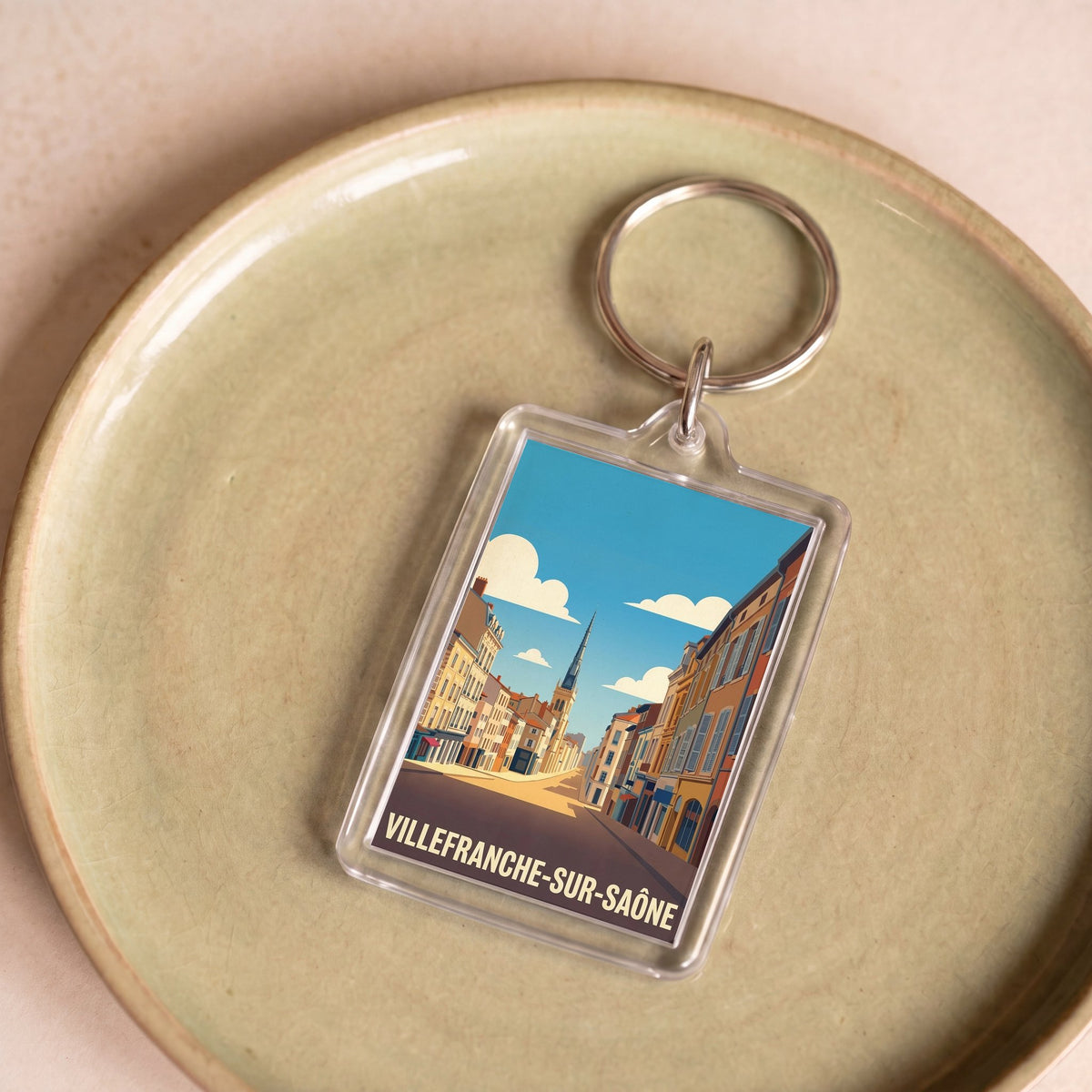 Porte-clés souvenir de la ville de Villefranche-sur-Saône avec une illustration stylisée.