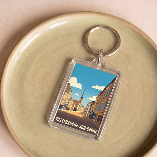 Porte-clés souvenir de la ville de Villefranche-sur-Saône avec une illustration stylisée.