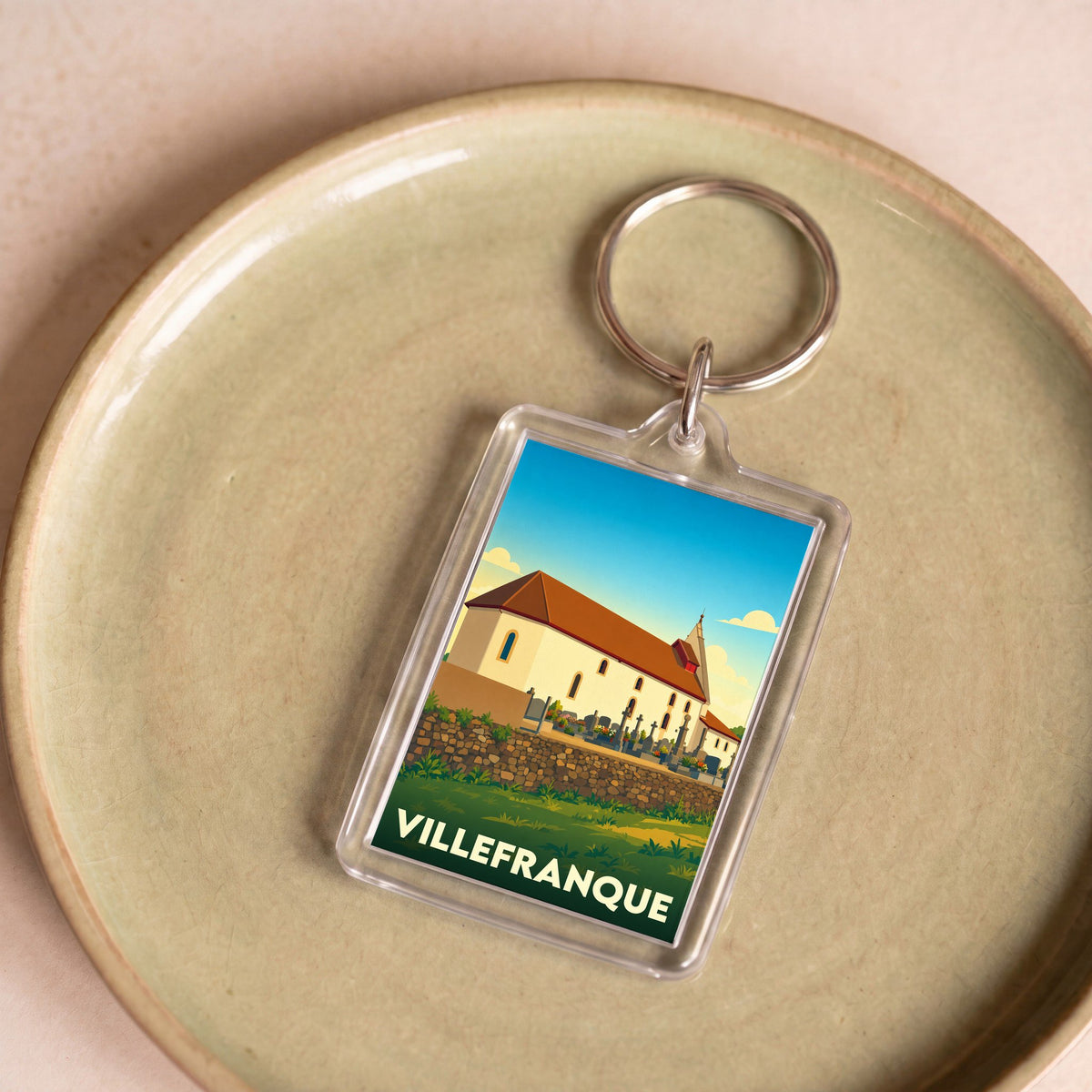 Porte-clés souvenir de la ville de Villefranque avec une illustration stylisée.