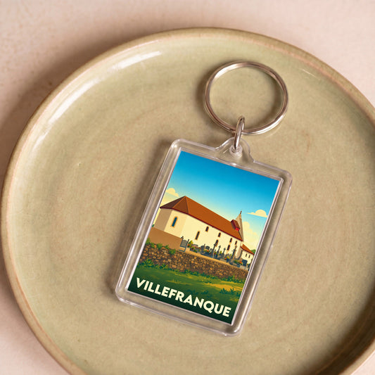 Porte-clés souvenir de la ville de Villefranque avec une illustration stylisée.