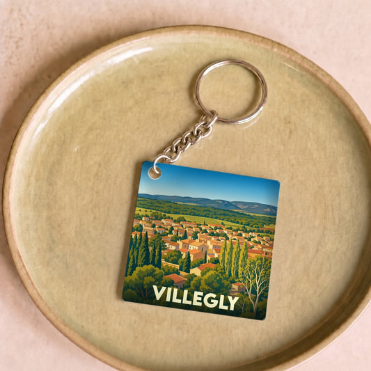 Porte-clés souvenir de la ville de Villegly avec une illustration stylisée.