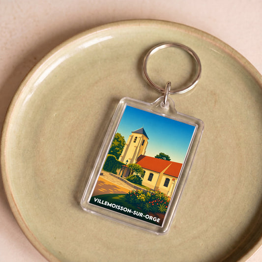 Porte-clés souvenir de la ville de Villemoisson-sur-Orge avec une illustration stylisée.