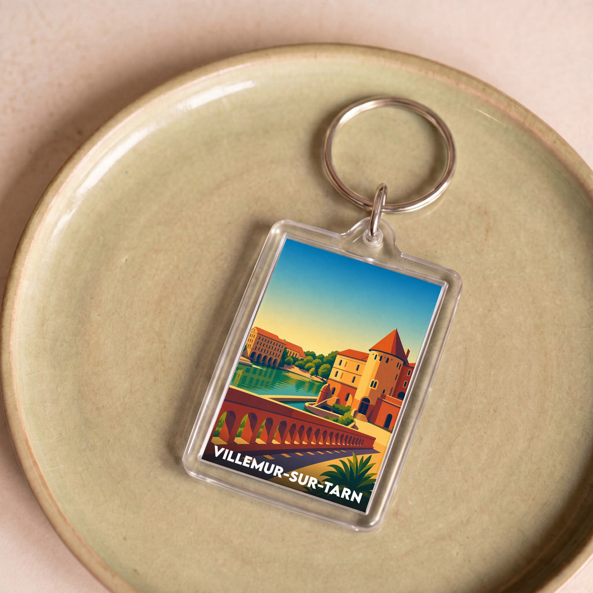 Porte-clés souvenir de la ville de Villemur-sur-Tarn avec une illustration stylisée.