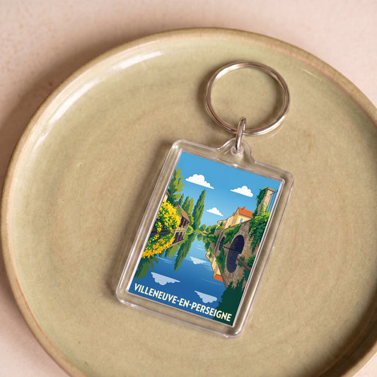 Porte-clés souvenir de la ville de Villeneuve-en-Perseigne avec une illustration stylisée.