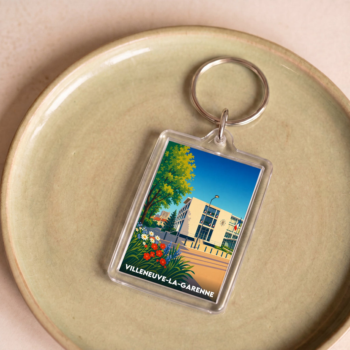 Porte-clés souvenir de la ville de Villeneuve-la-Garenne avec une illustration stylisée.
