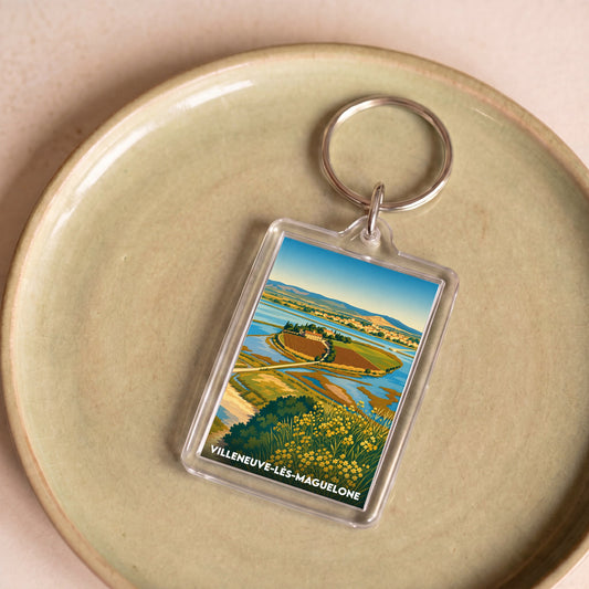 Porte-clés souvenir de la ville de Villeneuve-lès-Maguelone avec une illustration stylisée.