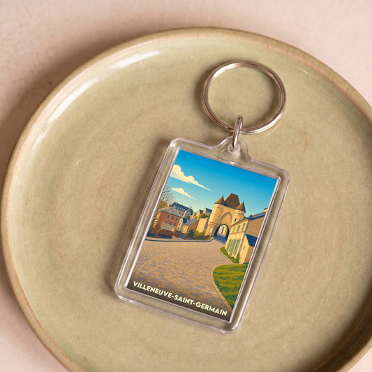 Porte-clés souvenir de la ville de Villeneuve-Saint-Germain avec une illustration stylisée de ses bâtiments historiques.