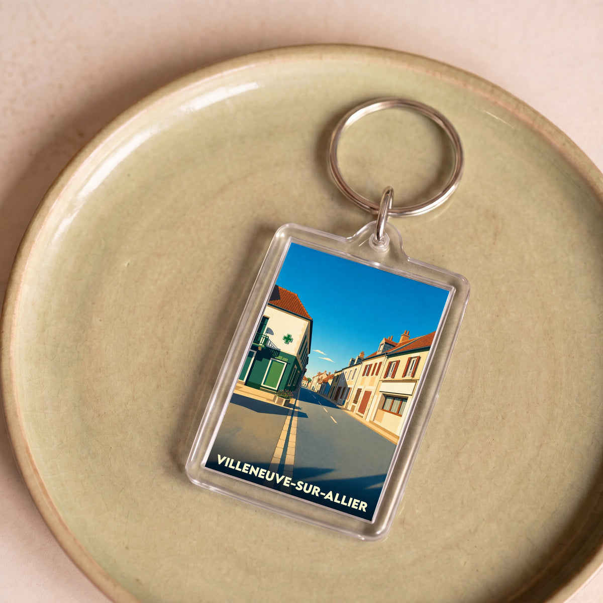 Porte-clés souvenir de la ville de Villeneuve-sur-Allier avec une illustration stylisée.
