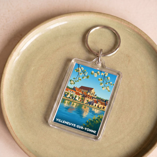 Porte-clés souvenir de la ville de Villeneuve-sur-Yonne avec une illustration stylisée.