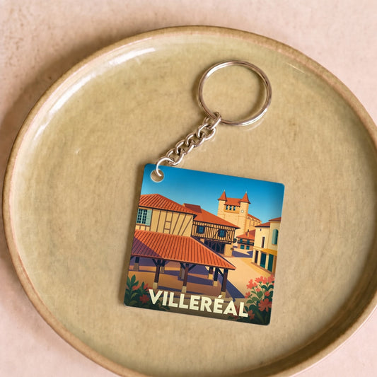 Porte-clés souvenir de la ville de Villeréal avec une illustration stylisée de sa halle et de son église.