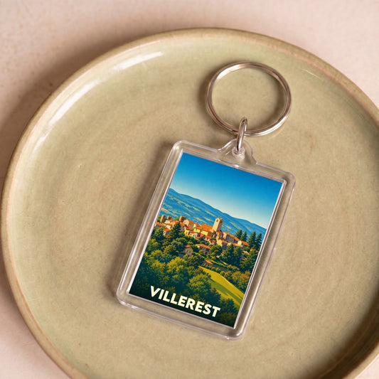 Porte-clés souvenir de la ville de Villerest avec une illustration stylisée d'un village perché.