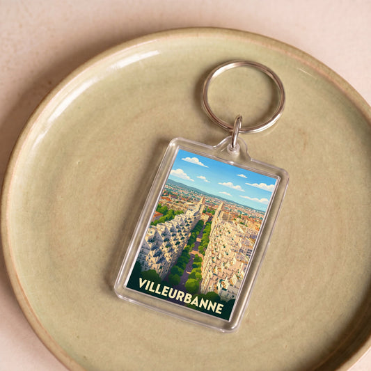 Porte-clés souvenir de la ville de Villeurbanne avec une illustration stylisée.