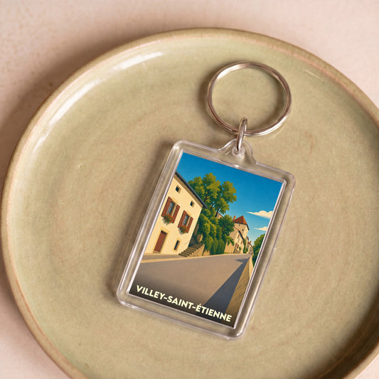 Porte-clés souvenir de la ville de Villey-Saint-Étienne avec une illustration stylisée.