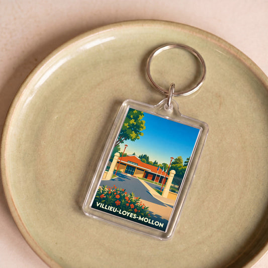 Porte-clés souvenir de la ville de Villieu-Loyes-Mollon avec une illustration stylisée.