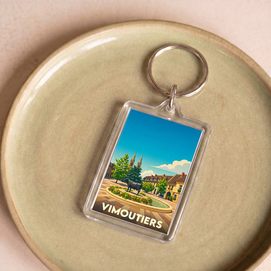 Porte-clés souvenir de la ville de Vimoutiers avec une illustration stylisée.