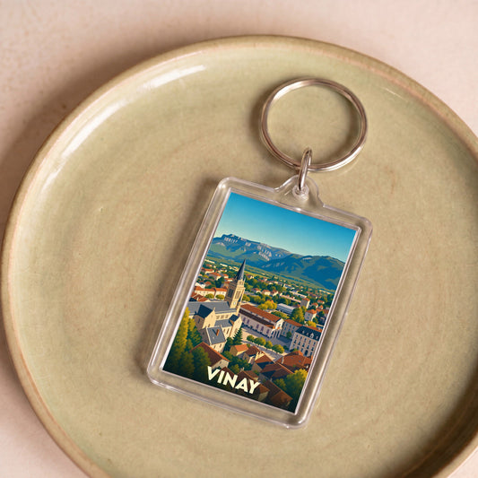 Porte-clés souvenir de la ville de Vinay avec une illustration stylisée.