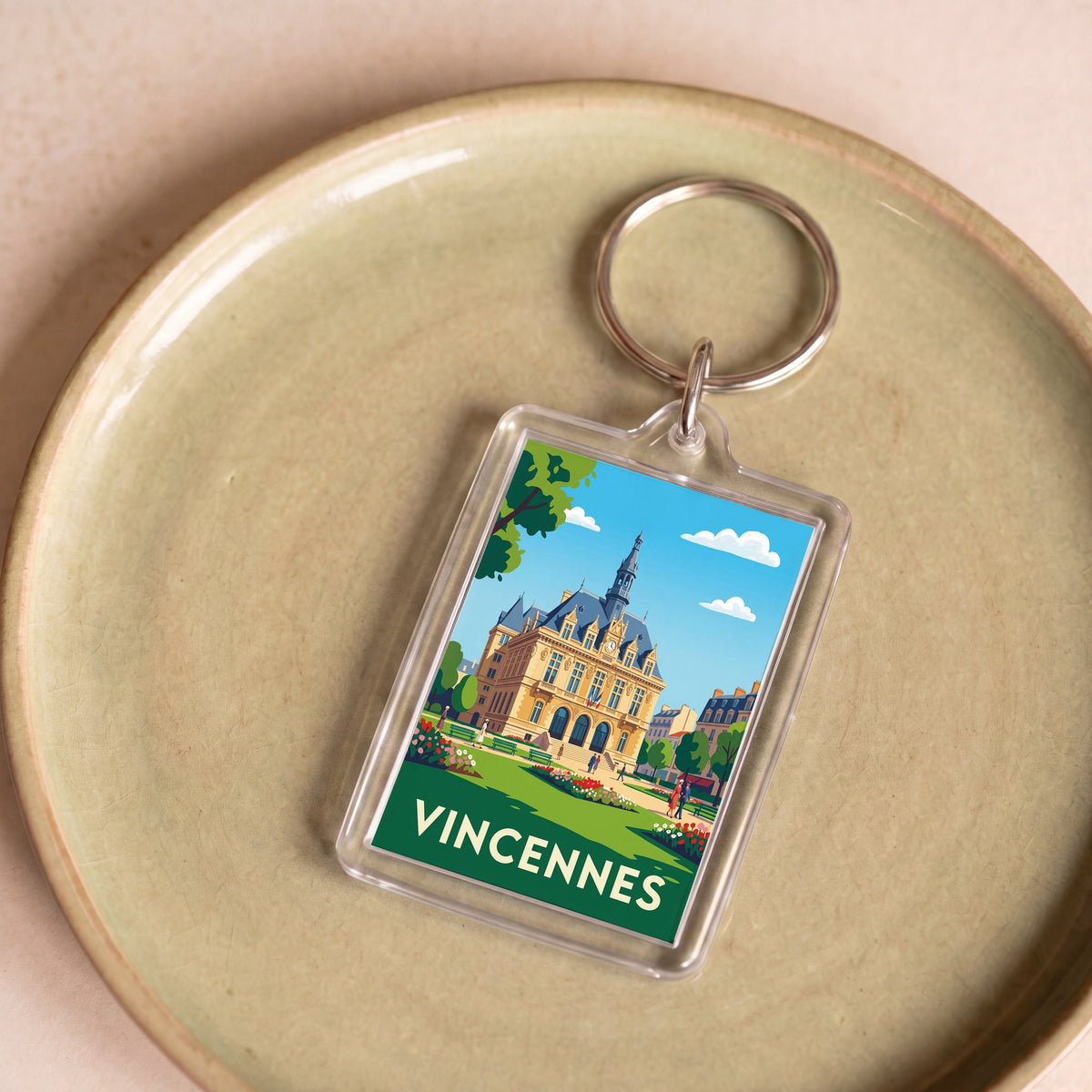 Porte-clés souvenir de la ville de Vincennes avec une illustration stylisée.