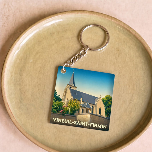 Porte-clés souvenir de la ville de Vineuil-Saint-Firmin avec une illustration stylisée de son église.