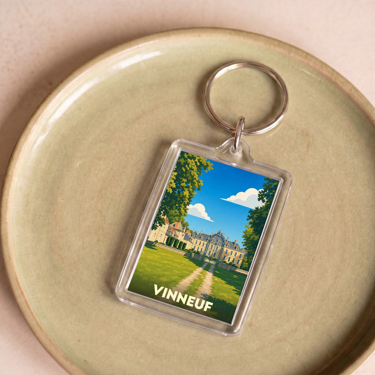 Porte-clés souvenir de la ville de Vinneuf avec une illustration stylisée de son château.