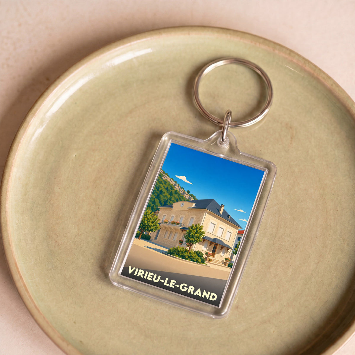 Porte-clés souvenir de la ville de Virieu-le-Grand avec une illustration stylisée.