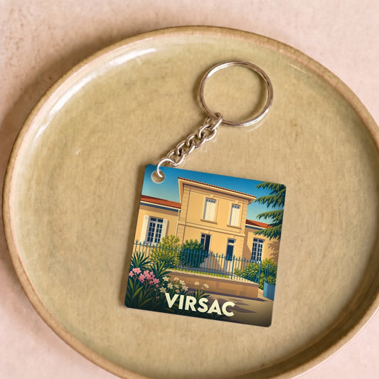 Porte-clés souvenir de la ville de Virsac avec une illustration stylisée d'une maison de maître.