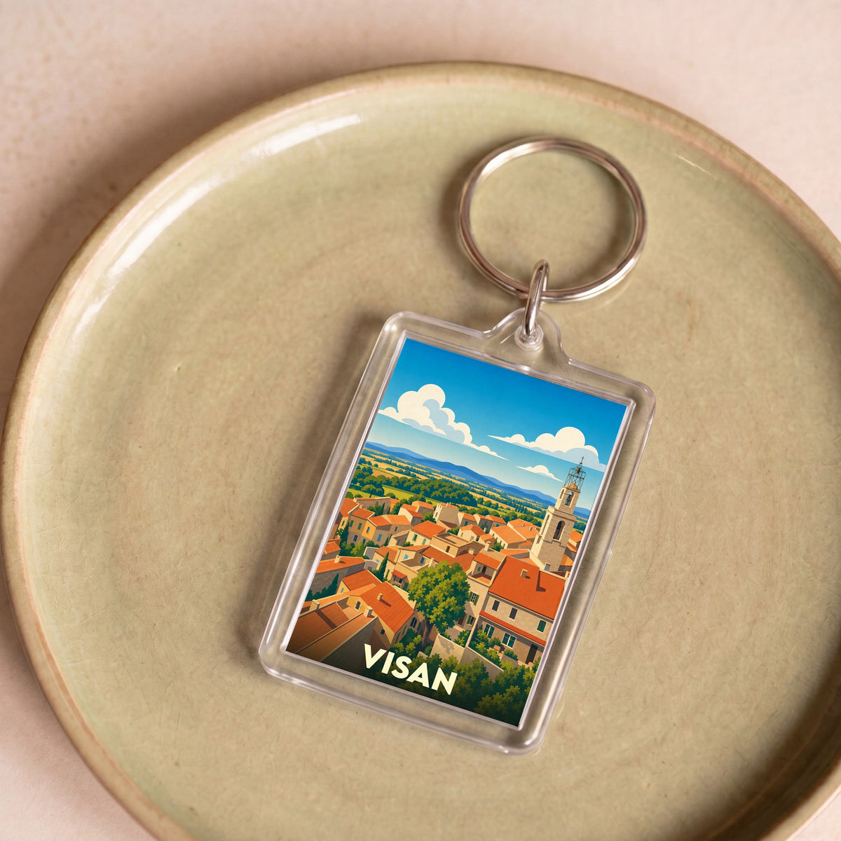 Porte-clés souvenir de la ville de Visan avec une illustration stylisée.