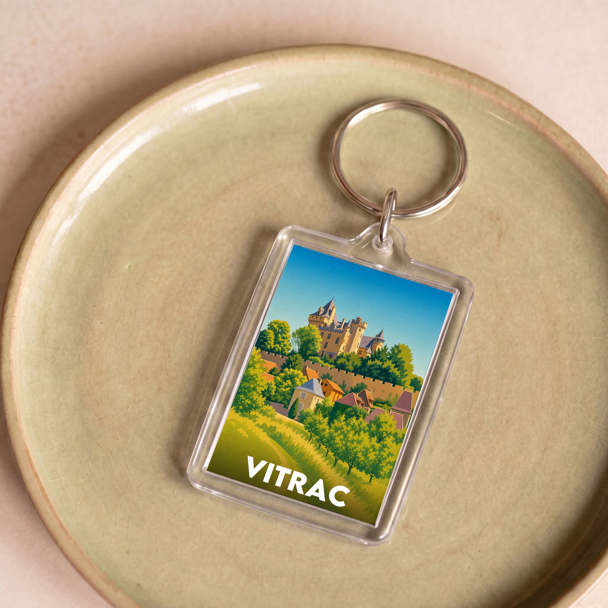 Porte-clés souvenir de la ville de Vitrac avec une illustration stylisée.