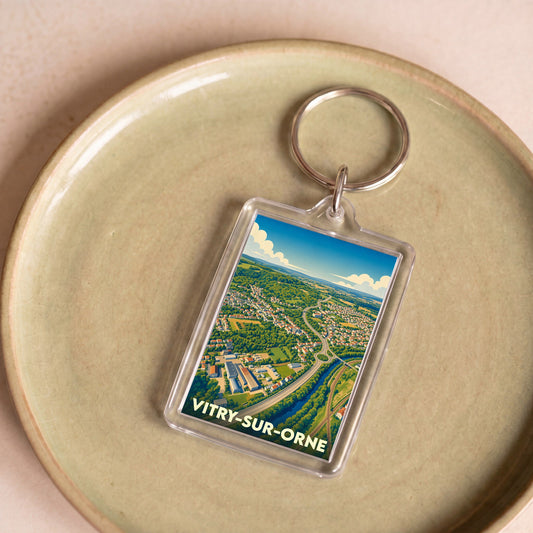 Porte-clés souvenir de la ville de Vitry-sur-Orne avec une illustration stylisée vue du ciel.