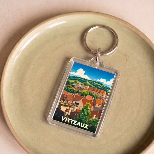 Porte-clés souvenir de la ville de Vitteaux avec une illustration stylisée d'un paysage urbain.